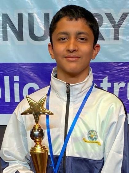 Another portrait of Atharva with his trophy and medal.