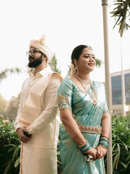 A stylish portrait of a couple in their traditional South Indian wedding attire.