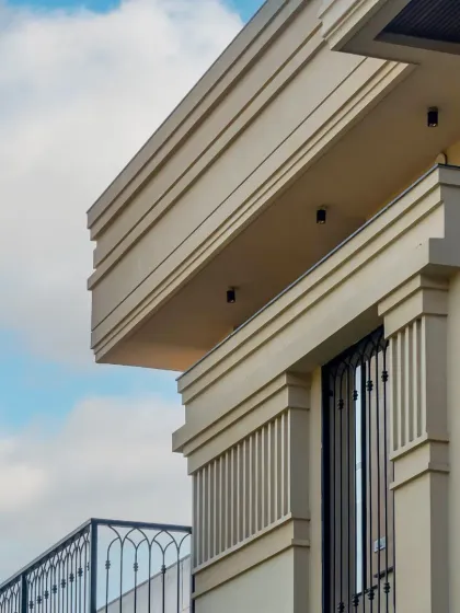 A sneak peek of a new facade, hinting at the classical details and clean lines that define my timeless designs. This close-up invites curiosity about the full reveal.
