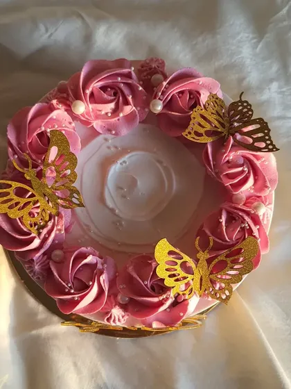 This beautiful pink cake was actually a mango cake inside. I decorated it with piped pink rosettes and delicate golden butterflies for an anniversary.