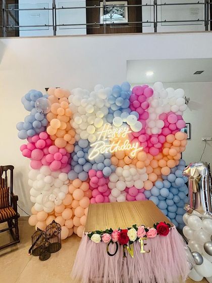 The full view of the home-based party setup with the large balloon wall, showing how it creates a grand celebration feel even indoors.