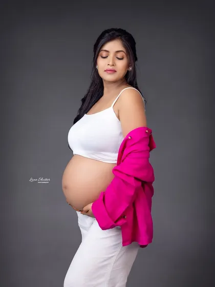 A beautiful bare-bump shot that is both tasteful and modern. The simple styling with the open shirt focuses on the amazing journey of creating life.