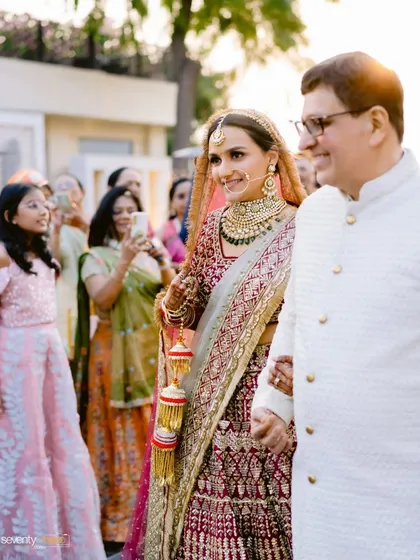 The bride walks down the aisle with her father, a proud and emotional moment filled with smiles and the love of family.