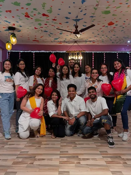 Our Valentine's-themed Holi workshop group photo, complete with red heart balloons. We celebrate all kinds of love!