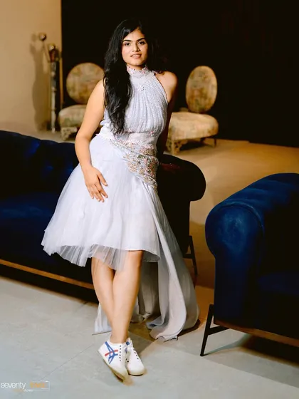 A stunning solo portrait of the bride. Her elegant dress paired with casual sneakers shows off her personality, creating a look that is both chic and uniquely her.