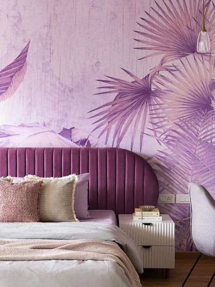 For a client who loves the color purple, I designed this bedroom with a statement wallpaper featuring tropical leaves. The curved, channel-tufted headboard in a darker purple adds a layer of luxury and comfort.