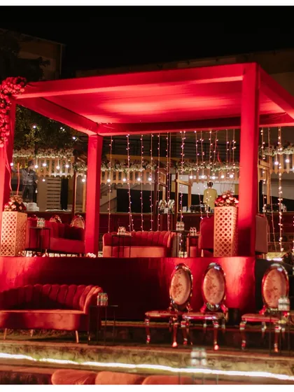 A closer look at the plush red velvet seating and elegant decor for a royal-themed reception.