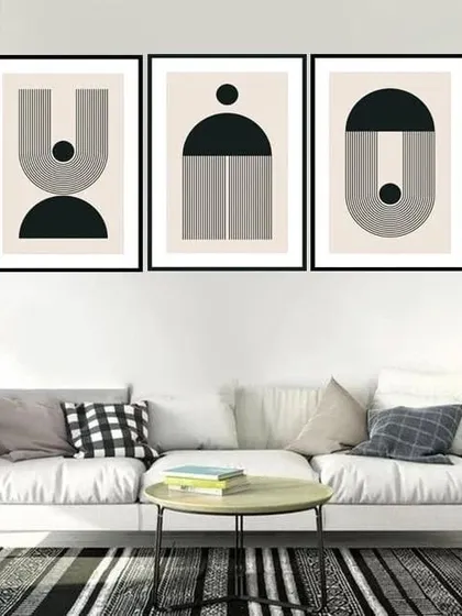 This set of three framed prints features ascetic geometric designs in black and white. The clean lines and minimalist shapes create a sophisticated and modern gallery wall.