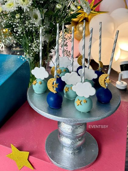 Adorable cake pops decorated with tiny moons, stars, and clouds to match the celestial theme.
