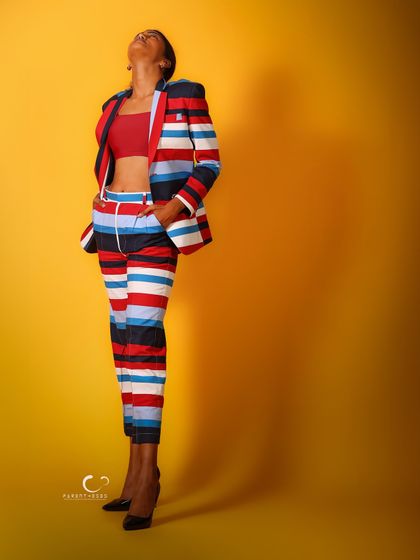 A full-length shot where the subject's pose and the shadow she casts create a dramatic and artistic composition.