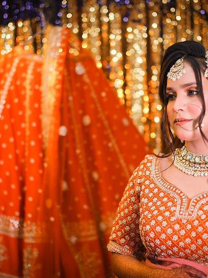 A creative portrait with the bride beside her hanging lehenga, telling the story of her transformation.