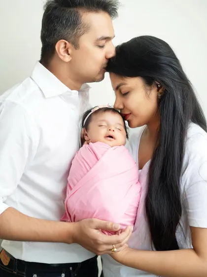 A father's gentle kiss on his wife's forehead is a small gesture full of love. I focus on capturing these details that make each family's story unique.