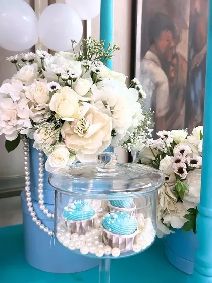 To celebrate a 500k milestone, we designed a surprise "Breakfast at Tiffany's" themed party, using the iconic Tiffany blue, white florals, pearls, and a custom dessert cart.