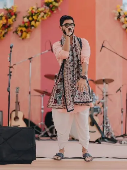 A playful pose on stage in the same traditional outfit. It's all about having fun with your look.
