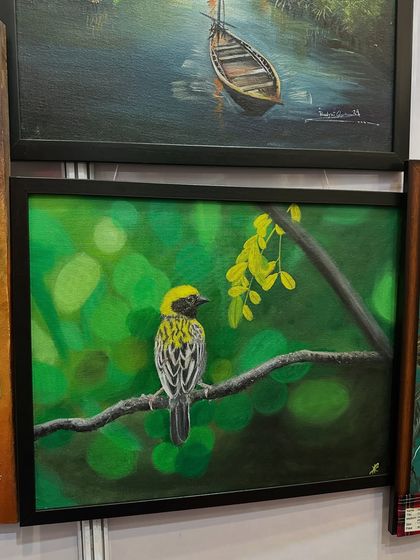 A view of some of my framed paintings, including a beautiful bird, at an exhibition at Pune Siddhi Banquet Hall.