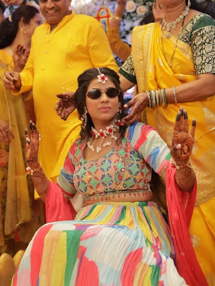 The cool bride moment! A fun shot of the bride wearing sunglasses during her Haldi ceremony.