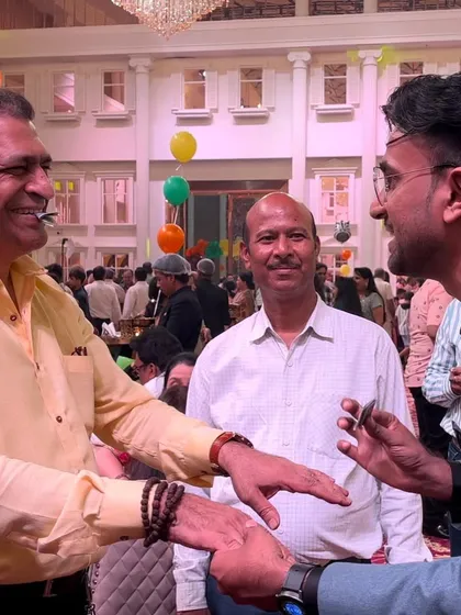 Sharing a laugh with a guest after a baffling coin trick. The best magic is not just fooling people, but connecting with them.
