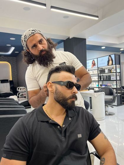 A side profile of a sharp fade in progress. The sunglasses add to the cool factor, but the haircut is the real star of the show.
