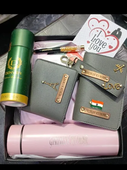 A travel-themed gift hamper for him, containing a personalized passport holder and wallet, a name-engraved temperature bottle, a pen, and deodorant.