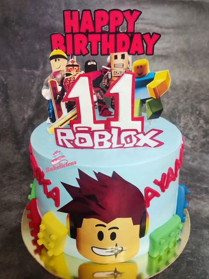 A vibrant Roblox-themed cake for an 11th birthday. This design features popular characters and logos from the game, making it a gamer's dream come true.