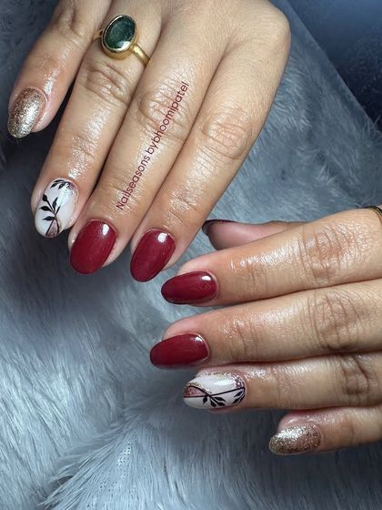 A beautiful design with deep red, gold glitter, and delicate black leaf patterns on a white base.