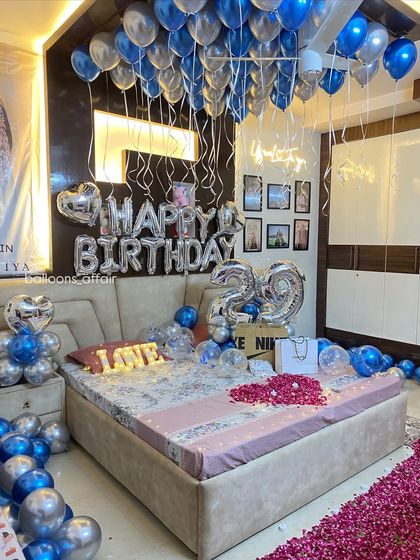 This angle showcases the density of the ceiling balloons and the custom neon sign, which adds a modern touch to the classic birthday balloon decoration.