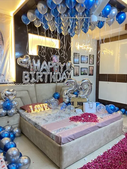 This angle showcases the density of the ceiling balloons and the custom neon sign, which adds a modern touch to the classic birthday balloon decoration.