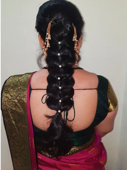 A back view of the bubble braid, showing the neat sections and pearl embellishments. This hairstyle is both elegant and trendy for pre-wedding functions.