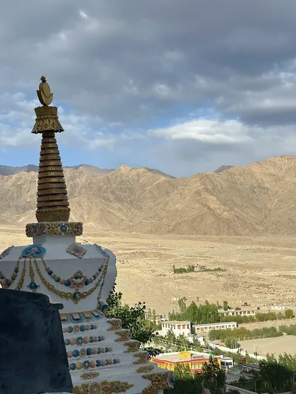 A stupa overlooking the vast, arid landscape of Ladakh. These structures are points of immense peace and spiritual energy, perfect for a moment of quiet meditation.