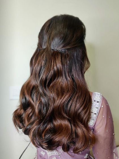 The hairstyle for Manasa's reception. We did a classic half-up, half-down style with beautiful, voluminous waves to complement her soft glam makeup.