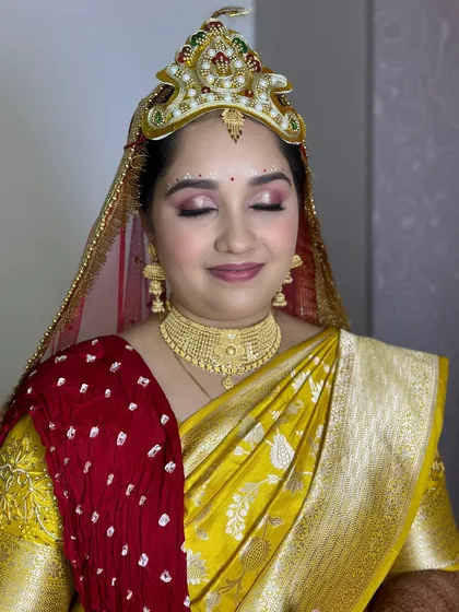 A detailed shot of the makeup for the ritual, with delicate bindi work on the forehead.