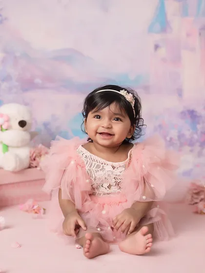 A full, happy smile from the half-birthday girl. These are the moments of pure joy that parents will cherish.