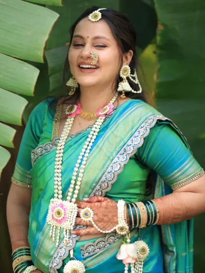 Pure joy and laughter. This mom-to-be is wearing a full set with a floral kamarband and kalire, looking absolutely radiant.