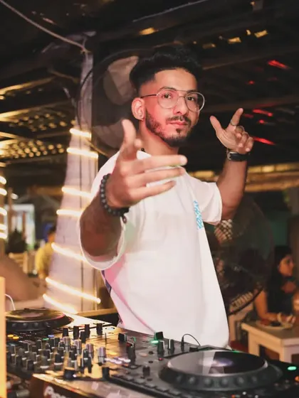 A candid shot of me in the DJ booth. This is where I feel most at home, creating musical experiences for others.