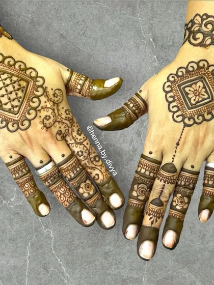 A geometric-inspired back-hand design. The square mandala is filled with intricate patterns, and the asymmetrical placement on one hand adds a modern touch.