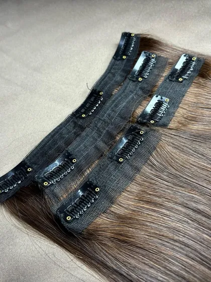 Another detailed view of the premium clip-on wefts. The meticulous stitching ensures the hair is secure, and the lightweight fabric base provides comfort for all-day wear.