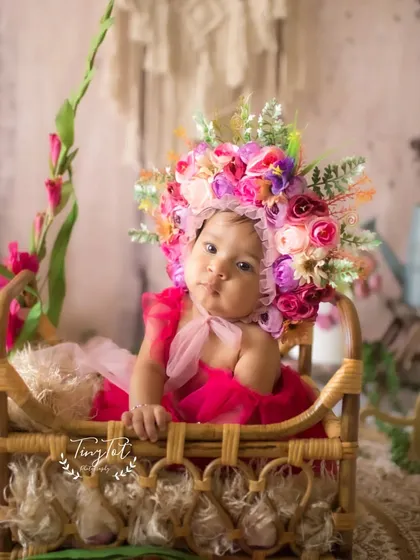 A beautiful portrait in a rustic basket, part of the bohemian floral theme for a sitter or half-birthday session.