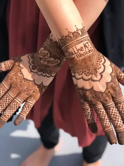A lovely design for the 'Dulhe ki Bhabhi' (groom's sister-in-law) with the couple's names, Faiza and Fahim, written on the hands.
