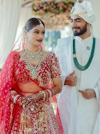 The happy couple, perfectly coordinated. Her bridal makeup complements his attire, creating a harmonious and picture-perfect look for their wedding day.