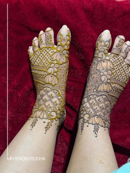 A beautiful bridal foot design featuring lotus motifs and intricate net patterns, providing full coverage for a traditional look.