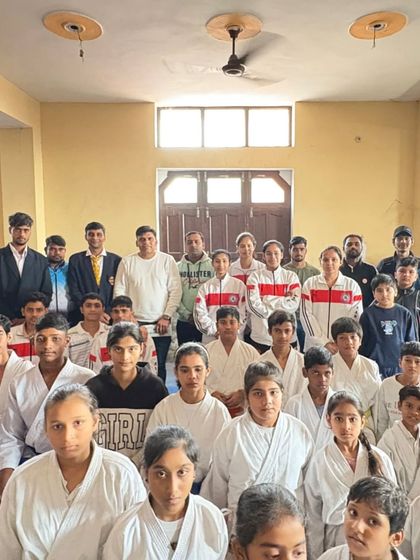 A group photo of the competitors, showing the range of students from different belt levels.