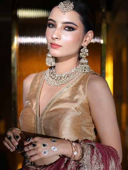 A confident pose showing off the full party look. The makeup is glamorous but not overpowering.