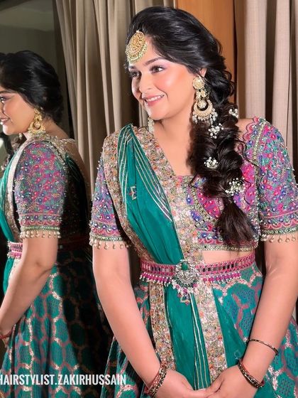 A beautiful side braid on a bride, decorated with baby's breath. This hairstyle is perfect for a Mehendi or Sangeet, keeping the hair neat while still looking festive.