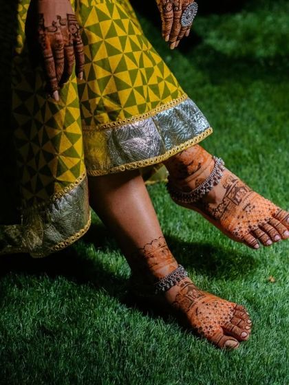A beautiful photo showcasing the bride's feet with silver anklets over the mehndi. The combination of henna and jewelry is simply timeless.