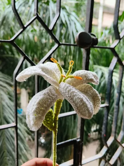 A single stem of my handmade white lily. I take care to shape the petals and add the yellow stamen for a realistic and elegant look.