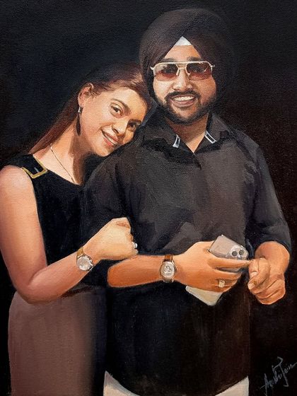 A cozy and intimate portrait of a couple. The dark background helps to highlight their faces and the warmth of their connection.