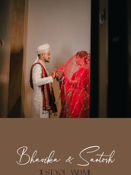 An artistic shot of the groom lifting the bride's veil, framed by a doorway to create a sense of intimacy and a new beginning.