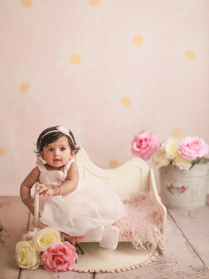 Celebrating six months with a lovely pink daisy-themed setup. I offer a variety of backdrops and props in my studio to create the perfect scene for your baby's half-birthday.