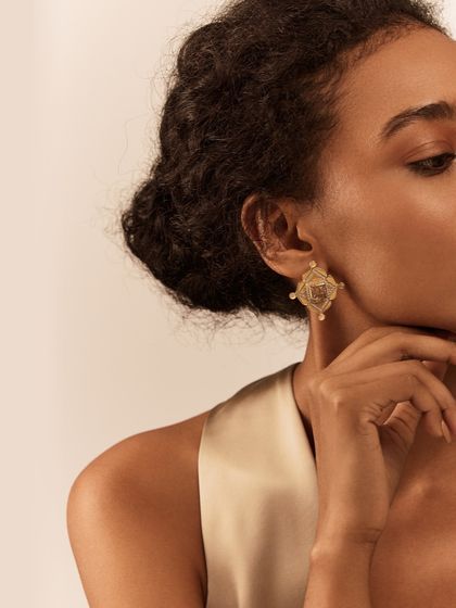 The Amelia Helios Earrings feature bold geometric patterns contrasted with intricate semi-precious stones. They are a statement pair that can transition seamlessly from a business meeting to an evening out.