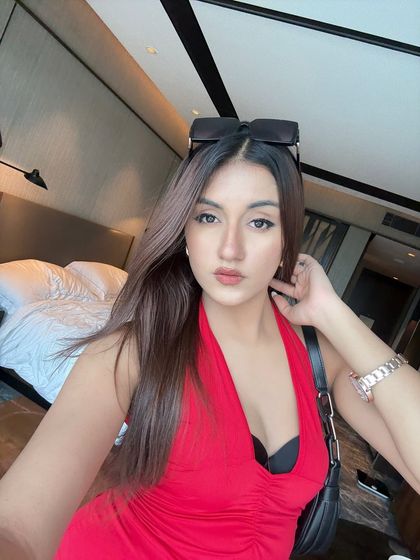 A selfie in a bold red halter-neck dress from Newme. The caption playfully asks, "red for danger or red for love?"